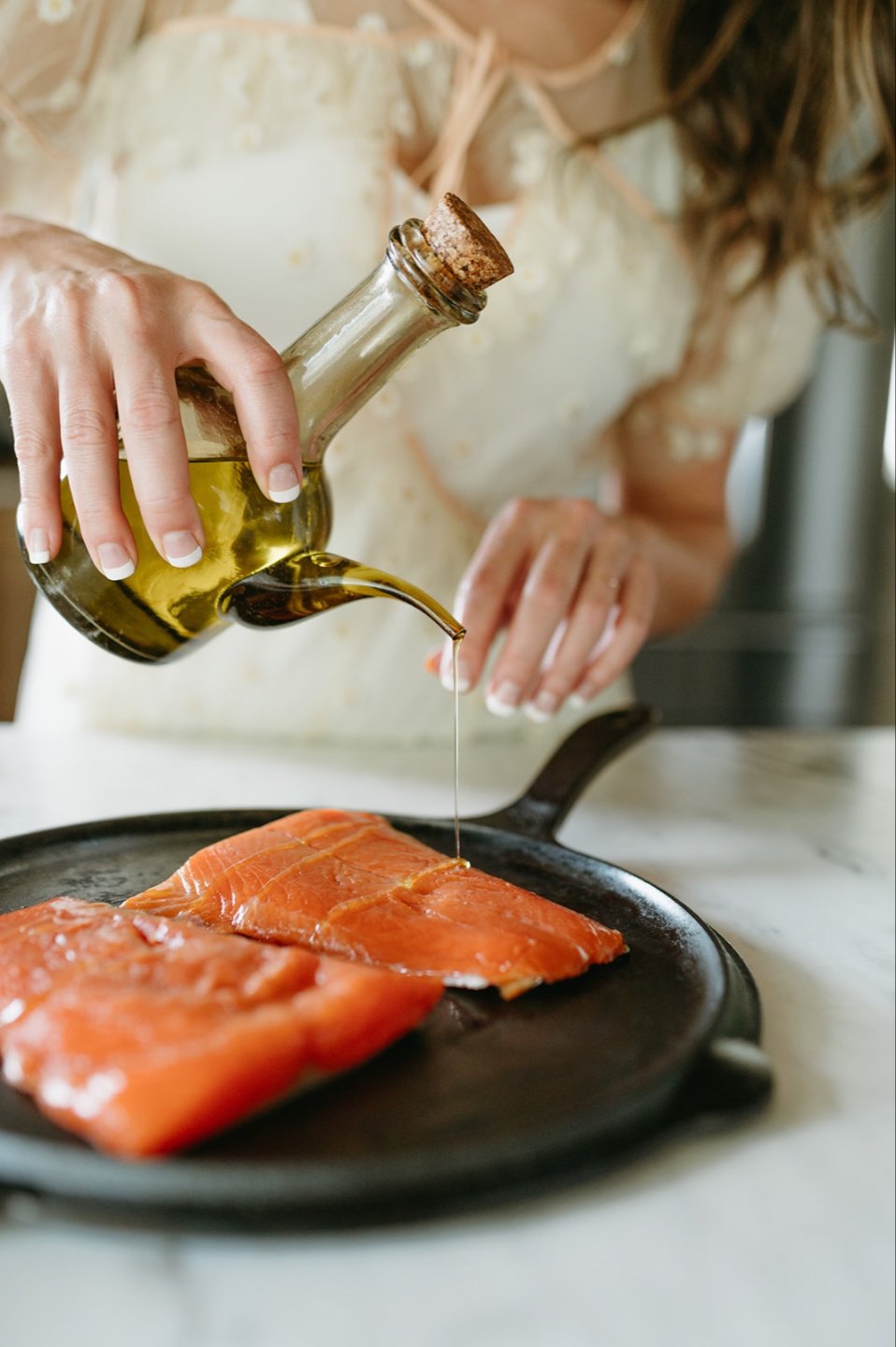 Aubrey leaning on counter with vegetables